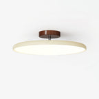 Adjustable ceiling lamp aimed over a seating area, warm glow