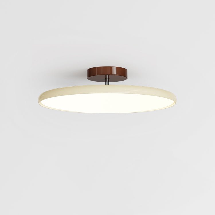 Round ceiling lamp on a swing arm casting warm diffused light