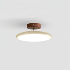 Adjustable swing-arm ceiling lamp with round acrylic shade glowing warm