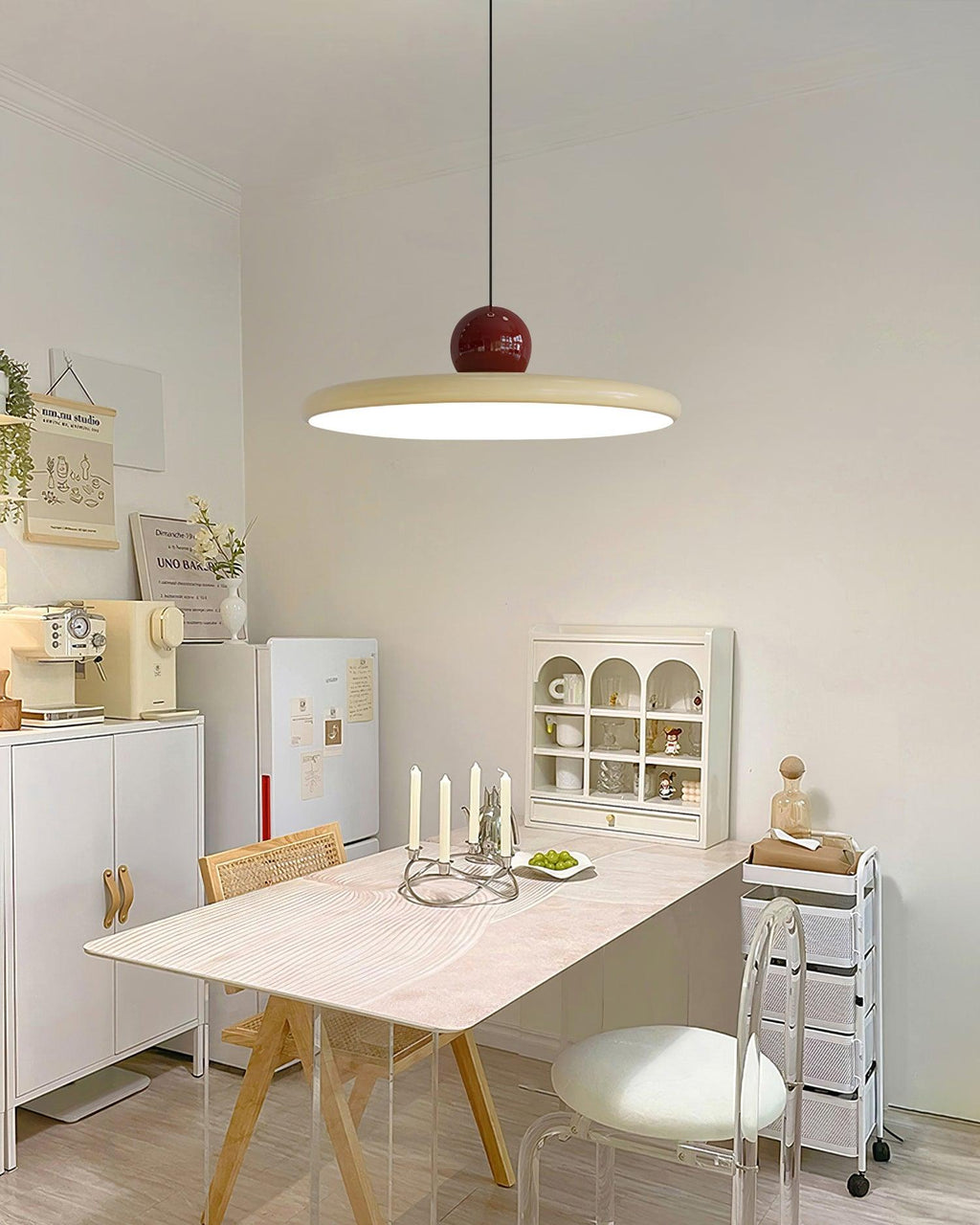 Disc pendant lamp glowing above a styled side table