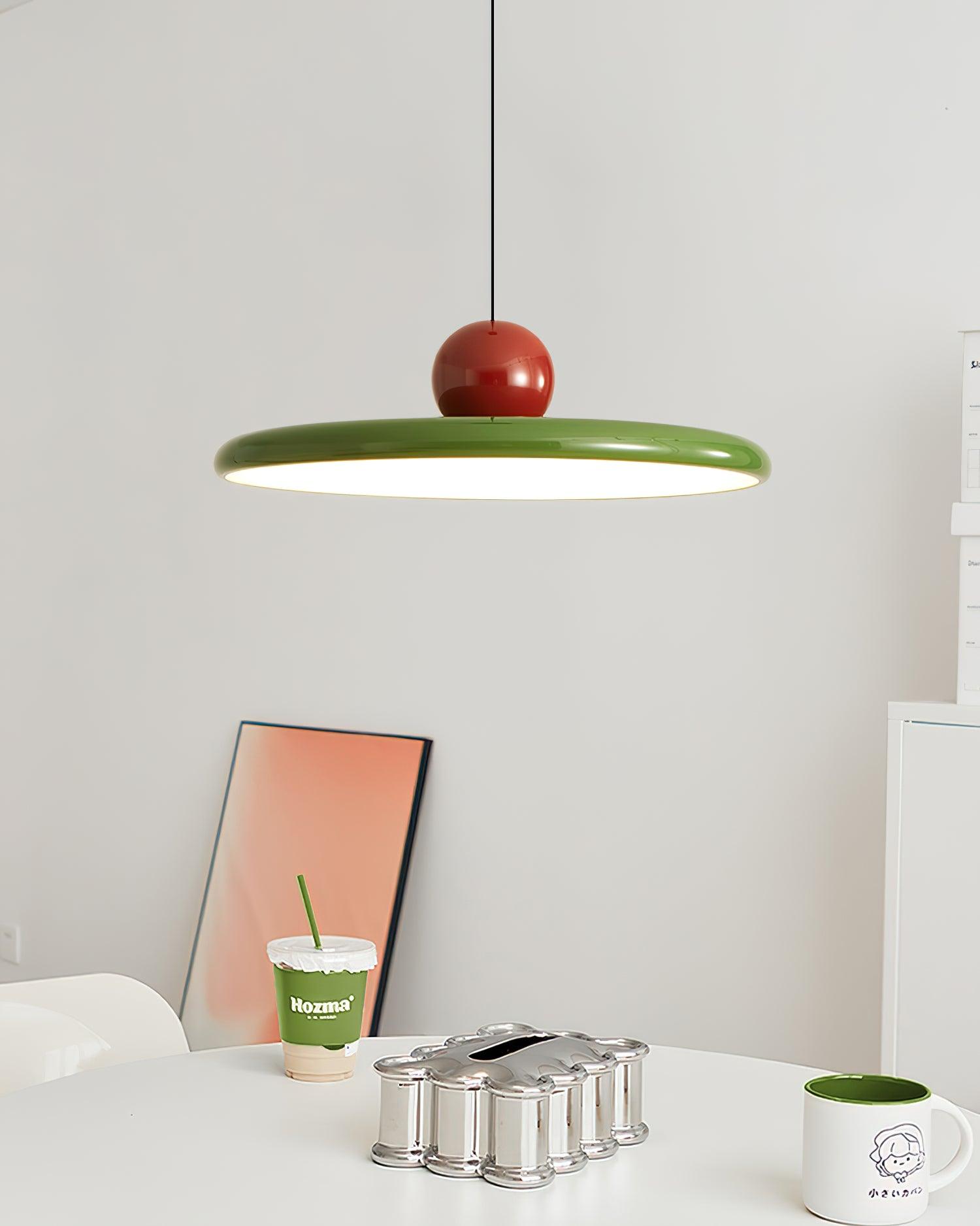 Round disc pendant light minimalist form against a wall