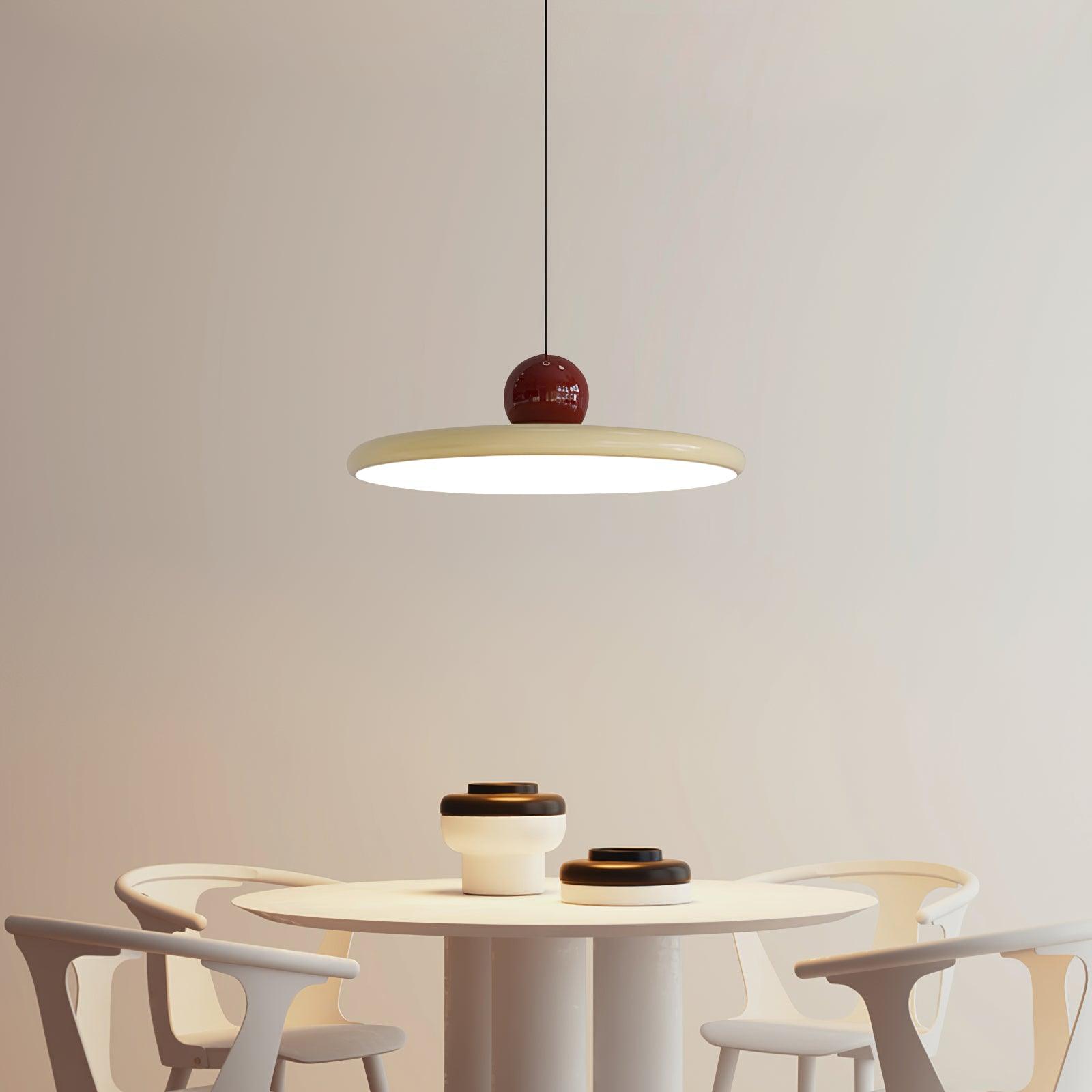 Disc pendant lamp casting soft light over a tabletop