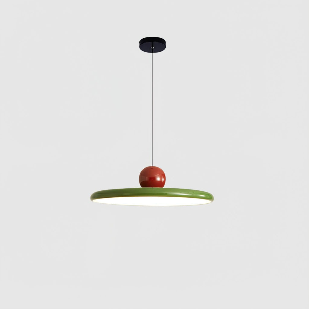 Round disc pendant light glowing warmly over a dining table