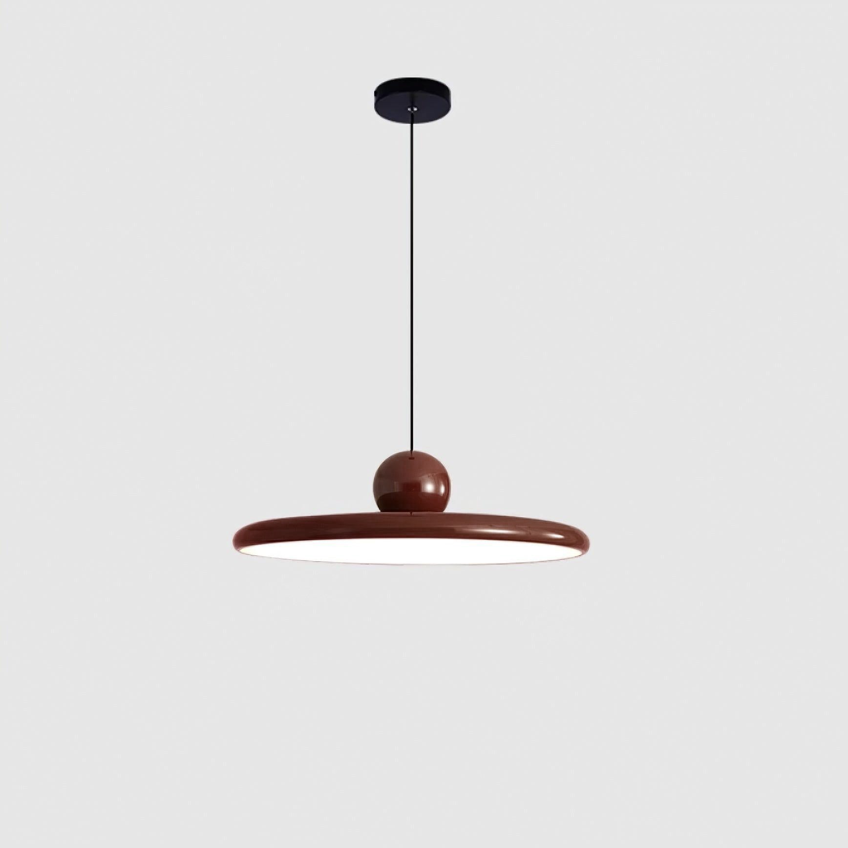 Round disc pendant light with white shade lit softly in a room