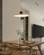 Round disc pendant light shown lit on a neutral backdrop