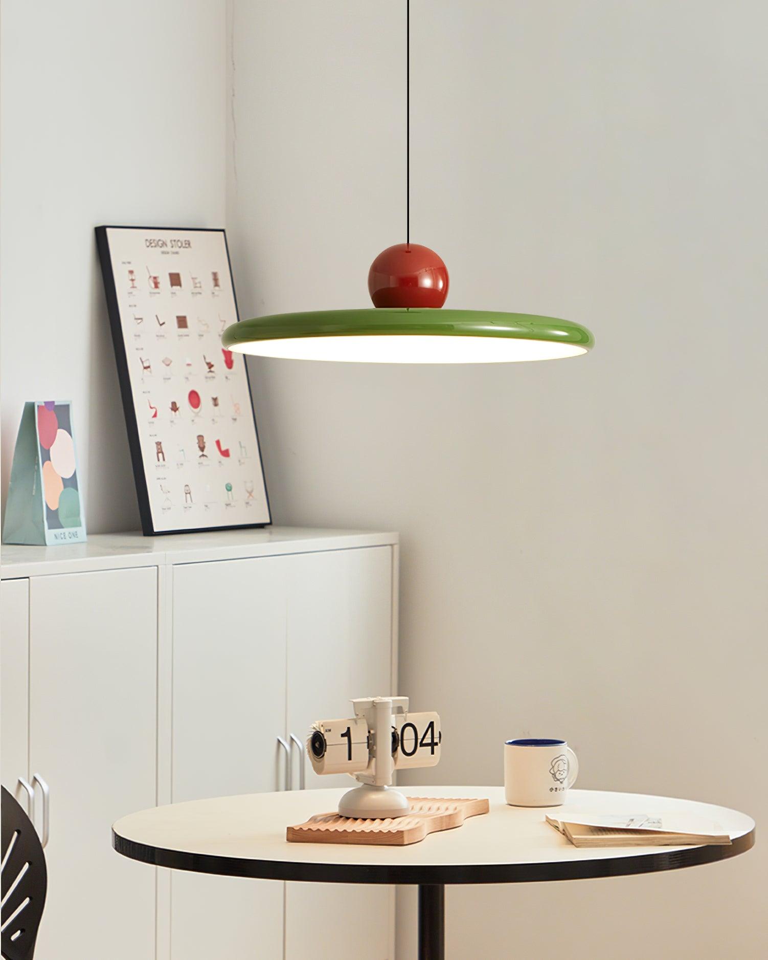 Round disc pendant light casting an even warm glow below