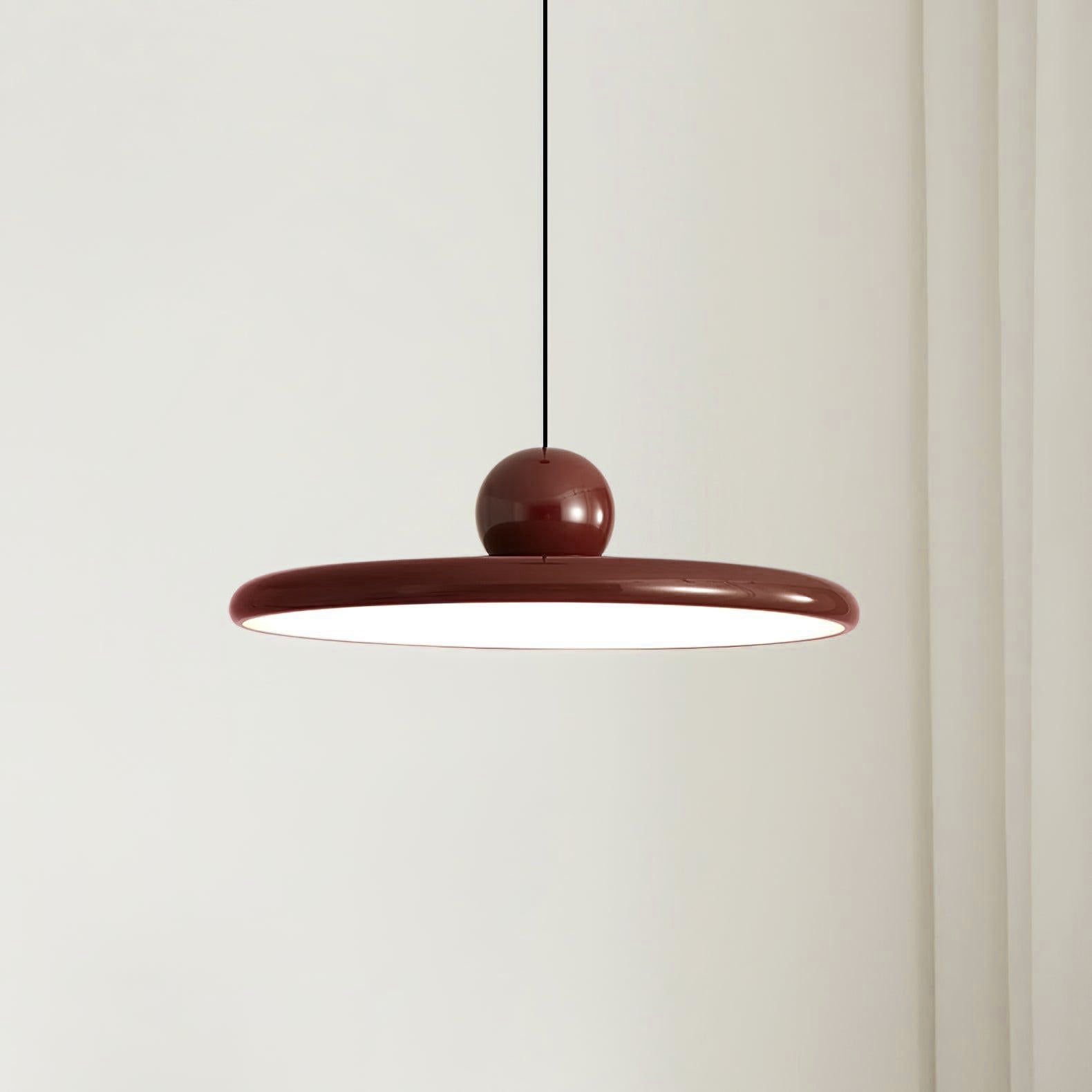 Round disc pendant light detail of the white glowing face