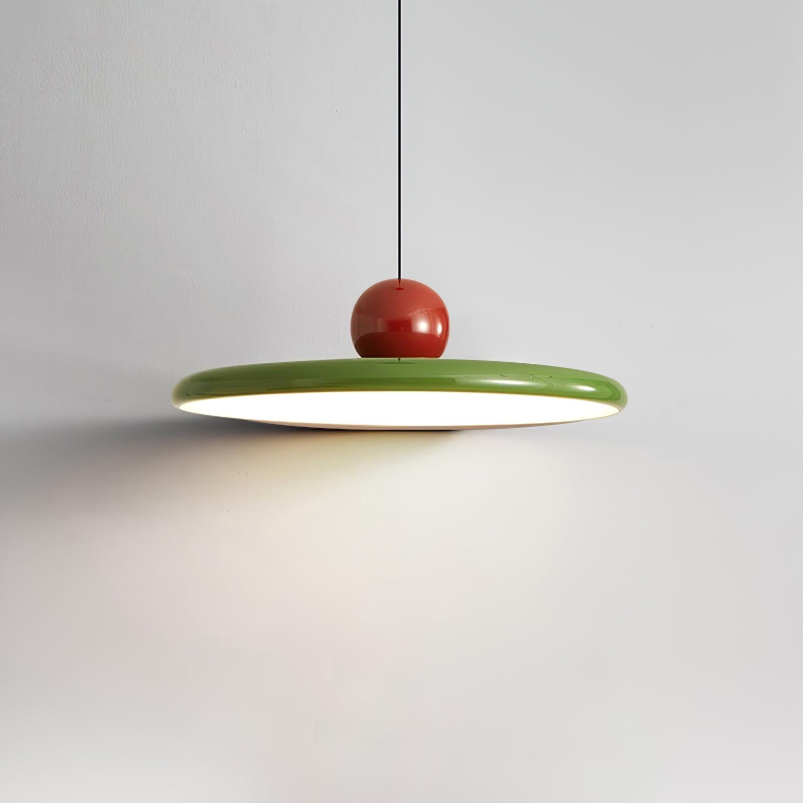 Round disc pendant light hung low over a dining setting