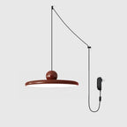 Slim disc pendant light hanging from a long plug-in cord