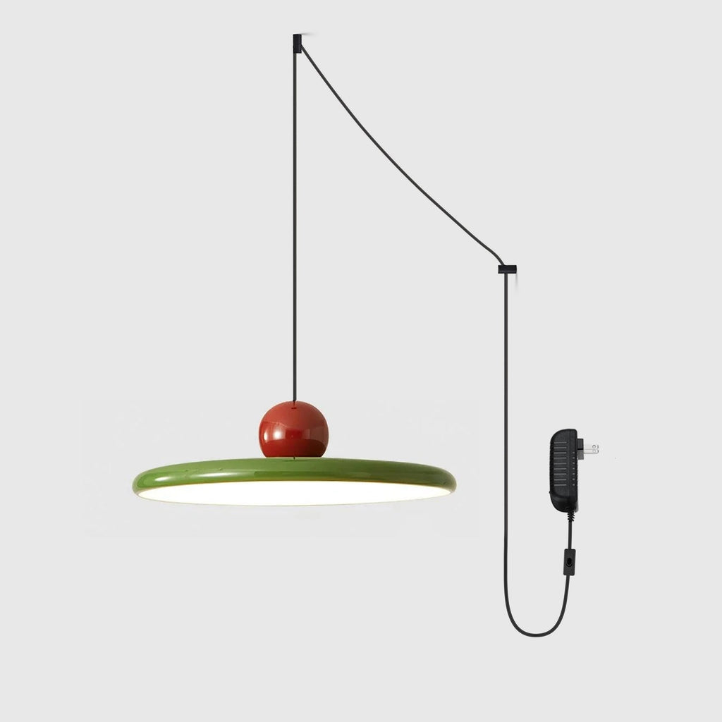 Minimalist disc pendant light casting warm light over a room