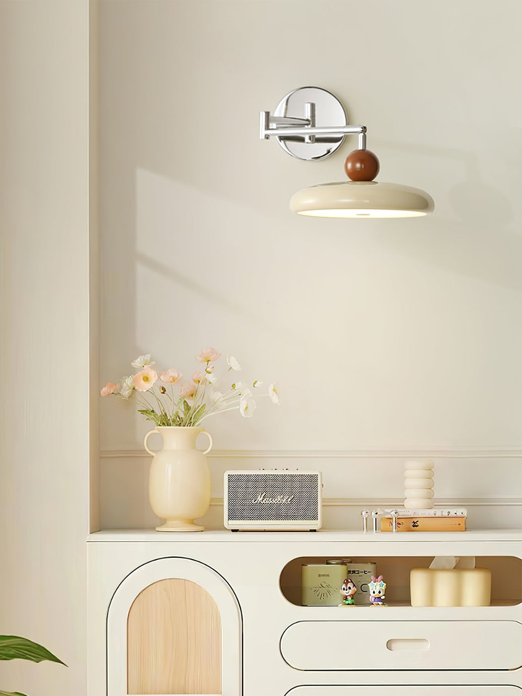 Round disc plug-in wall lamp shown unlit on a wall