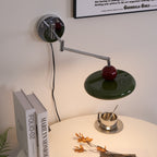 Round disc wall lamp lit softly in a cozy interior