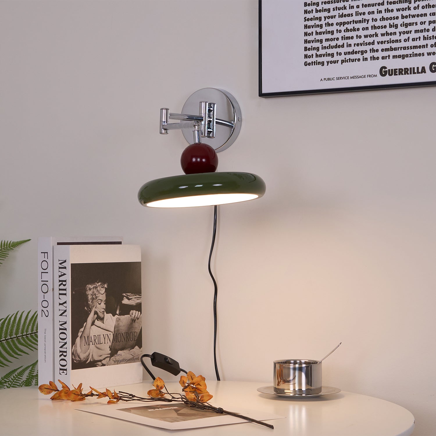 Round disc wall lamp glowing beside a styled headboard