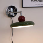 Round disc plug-in wall lamp shown on a clean background