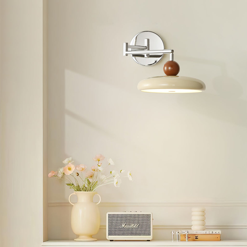 Round disc plug-in wall lamp side view showing the cord