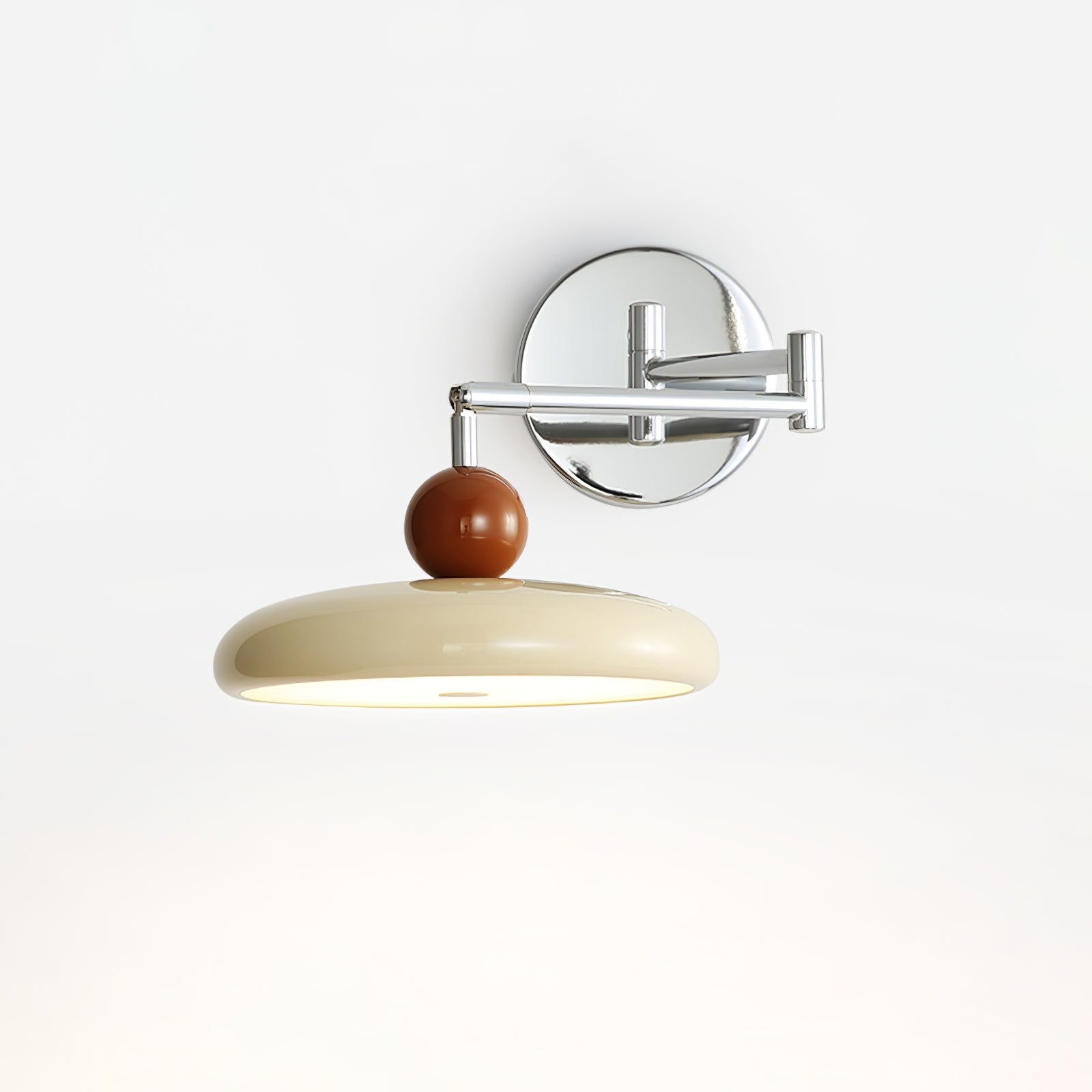 Round disc plug-in wall lamp shown on a neutral backdrop
