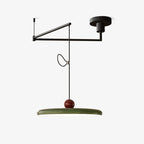 Swing arm pendant light glowing over a table with even downlight