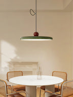Red and beige swing arm pendant light with lit acrylic disc