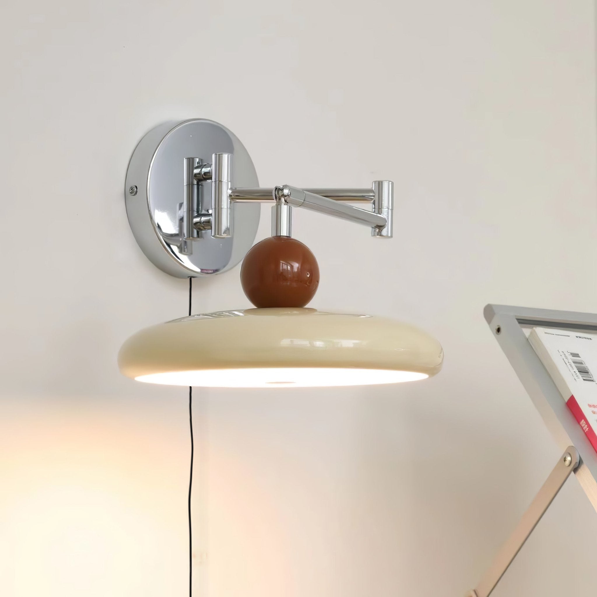 Round disc wall lamp shown with its inline cord switch