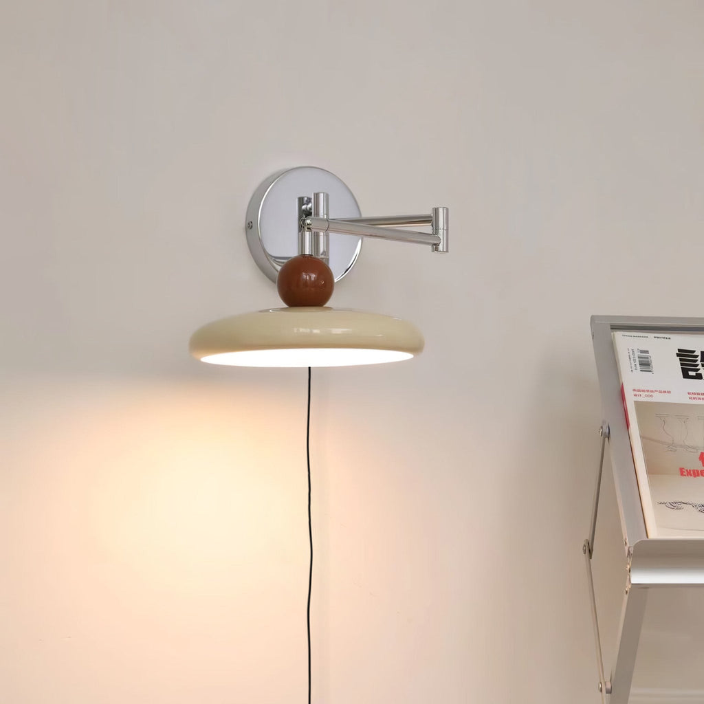 Round disc wall lamp casting a soft pool of light
