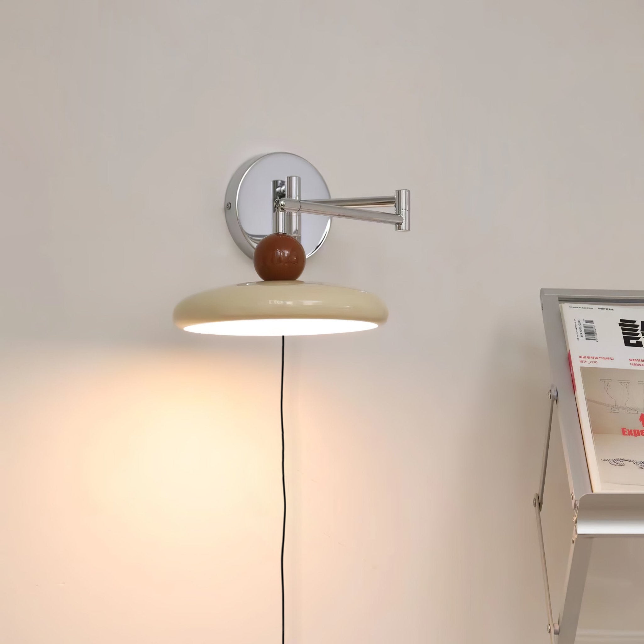 Round disc wall lamp casting a soft pool of light