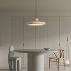 Yellow travertine pendant light with warm wood frame on neutral background