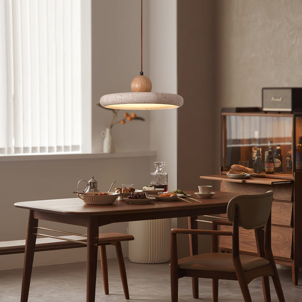 Yellow travertine pendant light with wooden frame above a dining table
