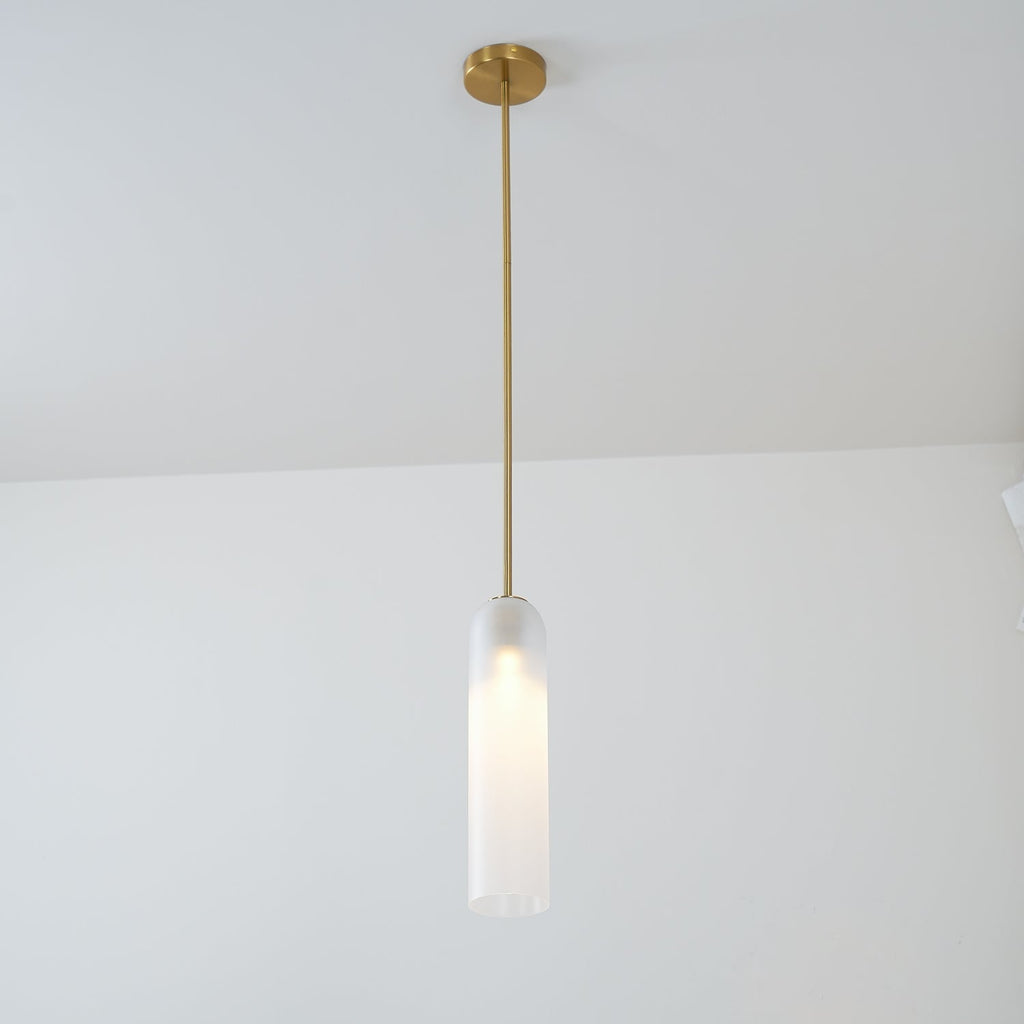 A single pendant of this Clérachic light in white glass hangs from a gold rod in a plain room corner.