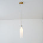 A single pendant of this Clérachic light in white glass hangs from a gold rod in a plain room corner.
