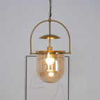 Close view of amber glass shade and hand-finished gold pendant body