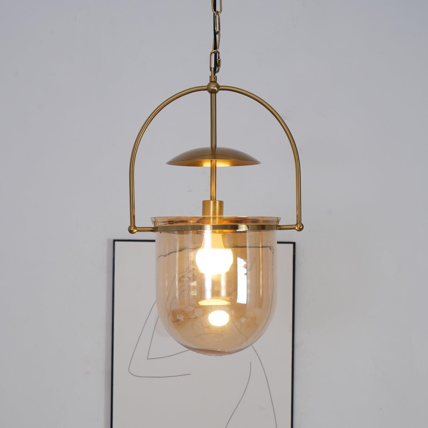 Close view of amber glass shade and hand-finished gold pendant body