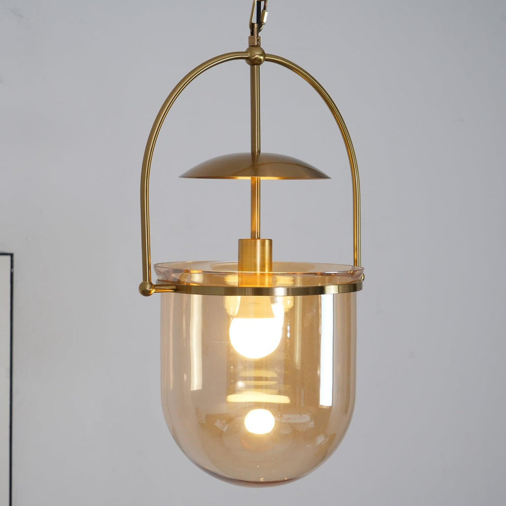 Gold frame pendant light with amber glass shade and ceiling canopy