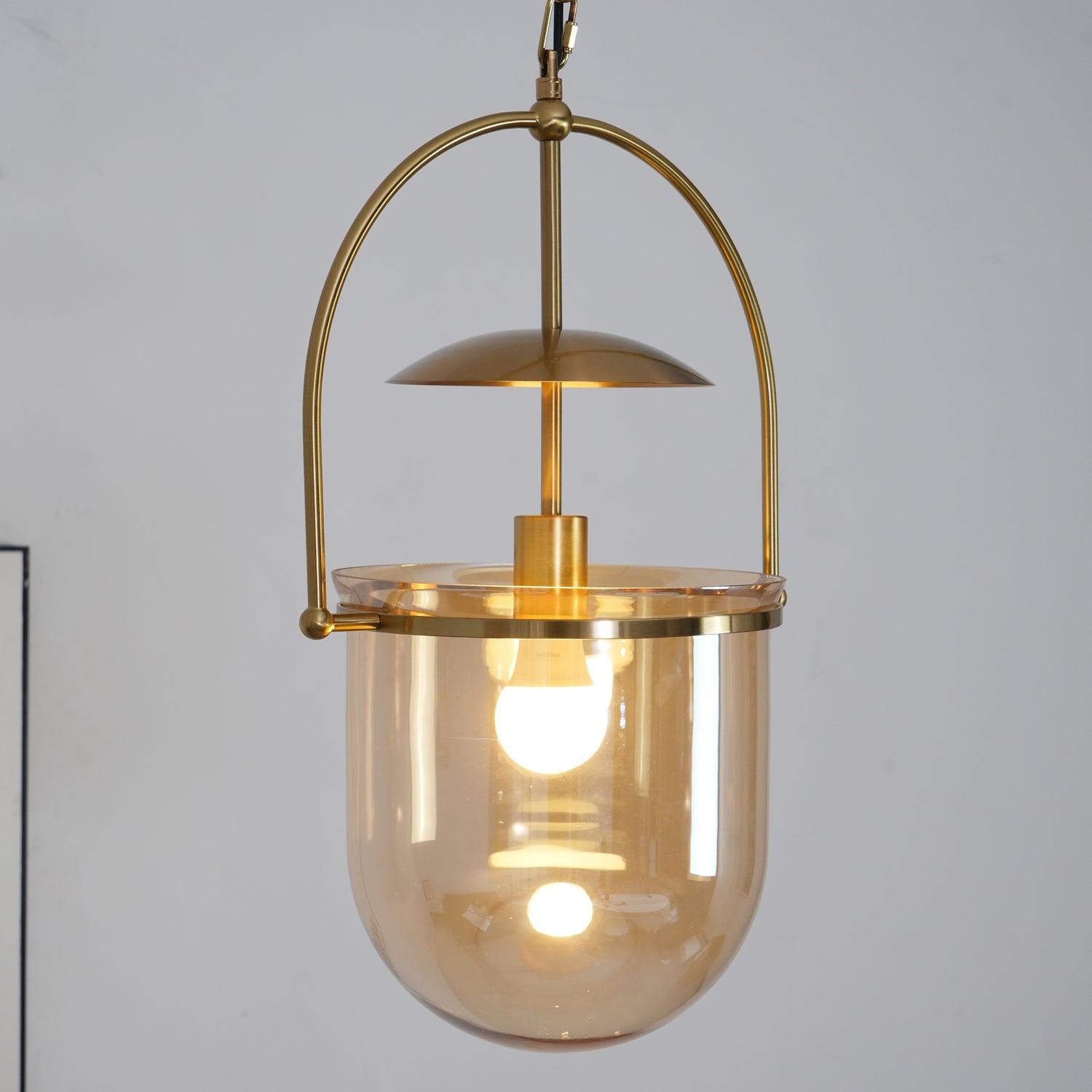 Gold frame pendant light with amber glass shade and ceiling canopy