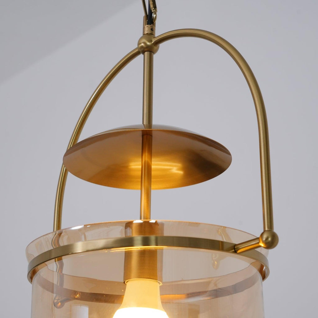 Amber glass cup pendant light with gold frame and slim suspension chain