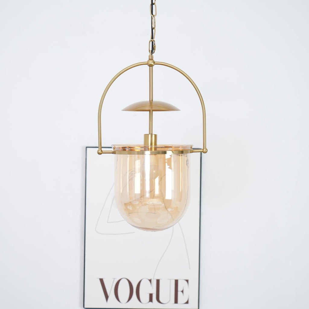 Side profile of amber glass pendant light with slim gold frame