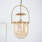 Detail of gold pendant frame holding an amber glass cup shade