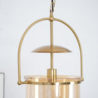 Gold frame pendant light with amber glass shade and black cord