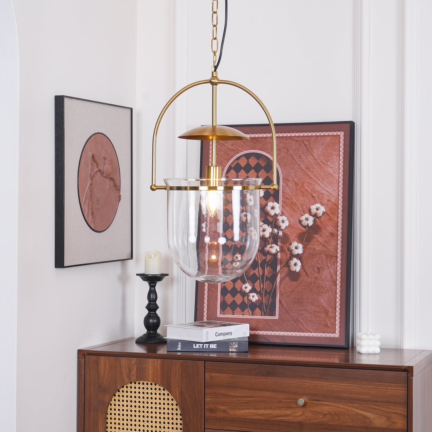 Clear glass pendant light with gold frame and visible Edison bulb