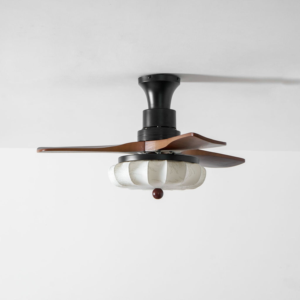 Walnut-blade ceiling fan with lotus shade in a bedroom setting