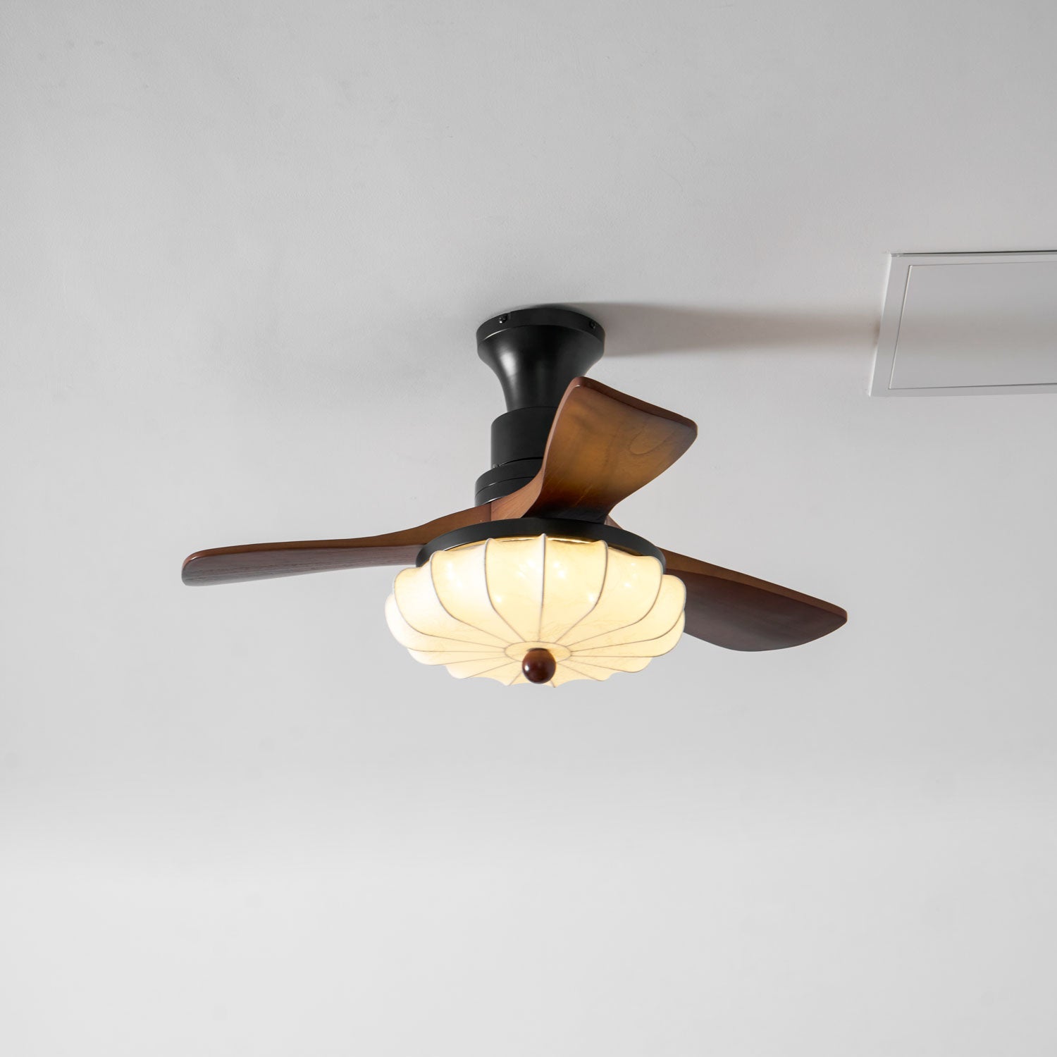 Ceiling fan light with fabric lotus shade mounted on ceiling