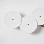 Lotus petal wall lamp with white ceramic shades lit warm