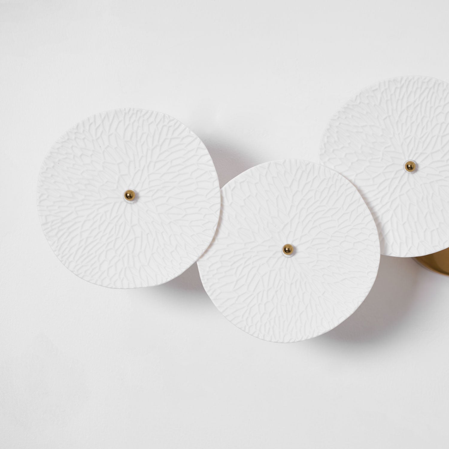 Lotus petal wall lamp with white ceramic shades lit warm
