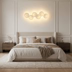 White ceramic lotus petal wall lamp on a gold spine