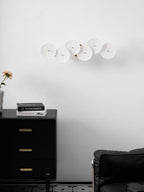 White ceramic lotus petals climbing a gold wall spine