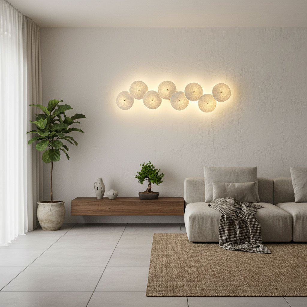 Layered white ceramic lotus petals on a gold light fixture