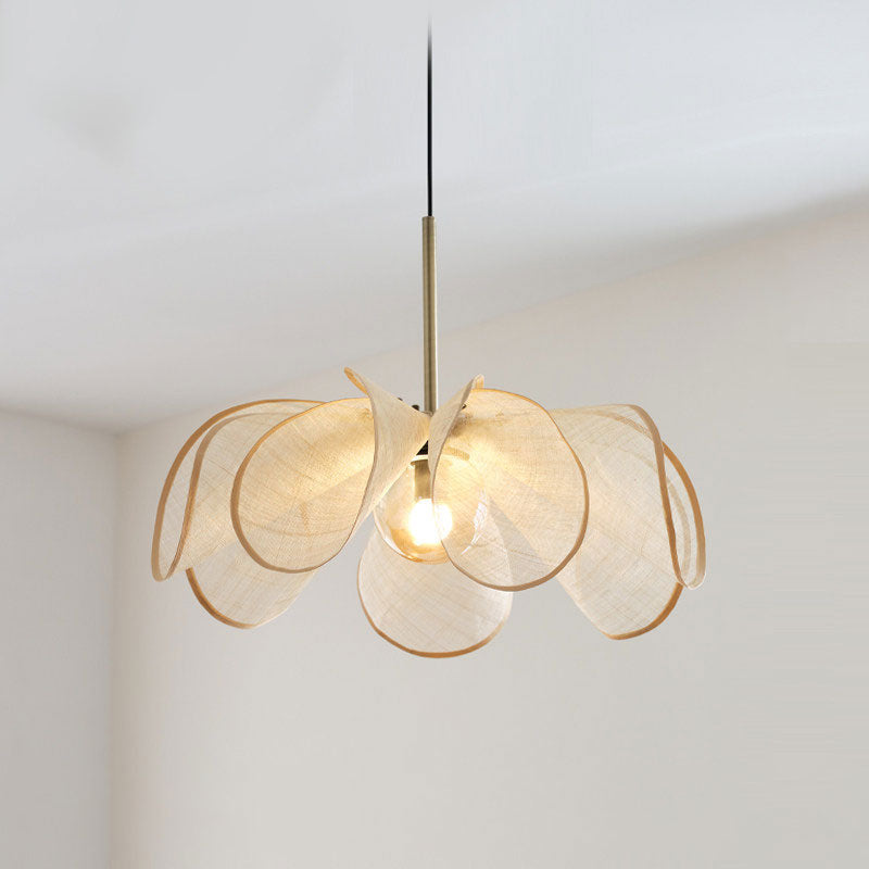 Close view of this Clérachic pendant's beige fiber petals curling open around a lit bulb, shot from below.