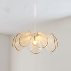Close view of this Clérachic pendant's beige fiber petals curling open around a lit bulb, shot from below.