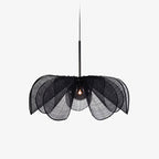 On a plain backdrop, this Clérachic pendant's black fiber petals splay outward beneath a slim black stem.