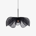 On a plain grey backdrop, this Clérachic pendant shows its black fiber petals fanned open around a lit bulb.