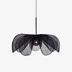 On a plain grey backdrop, this Clérachic pendant shows its black fiber petals fanned open around a lit bulb.
